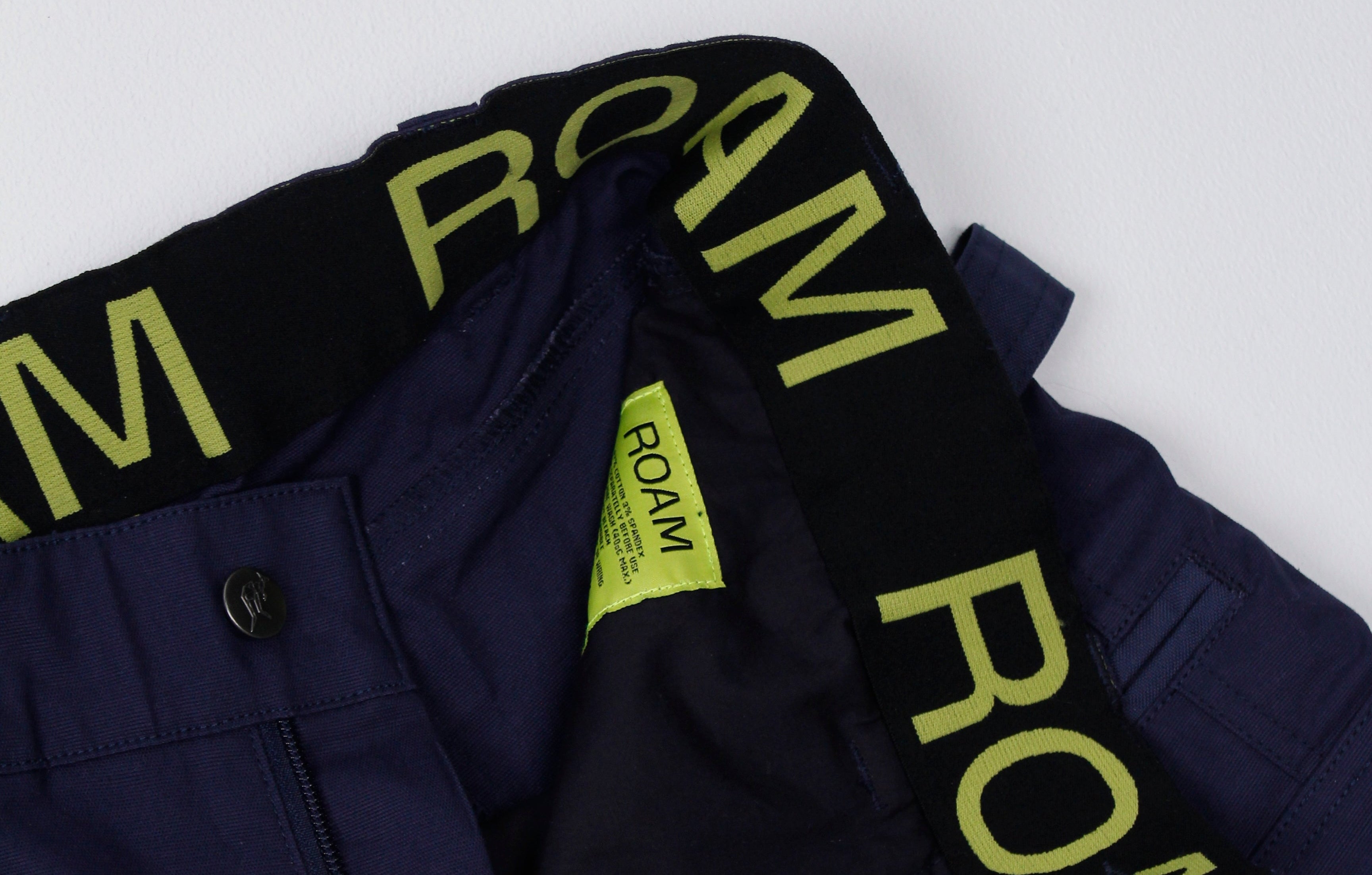 Navy pants with 'ROAM' branding on a white background